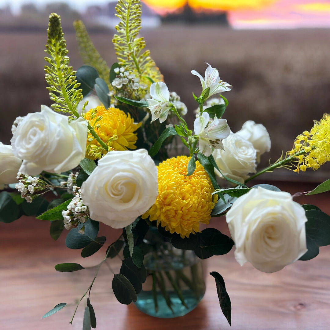 Roses and Chrysanthemum blooms are presented in vase with Eremurus Foxtail lilies 