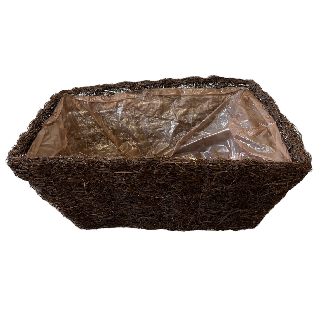Coconut fiber pot with plastic liner on a white background