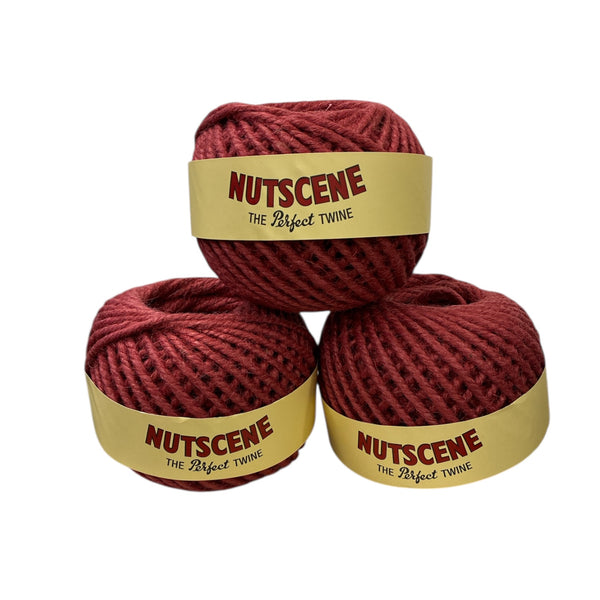 Three balls of red twine with 'Nutscene' labels on a white background
