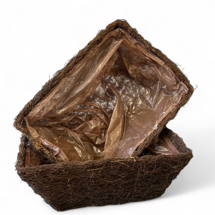 Coconut fiber basket with a plastic liner on a white background