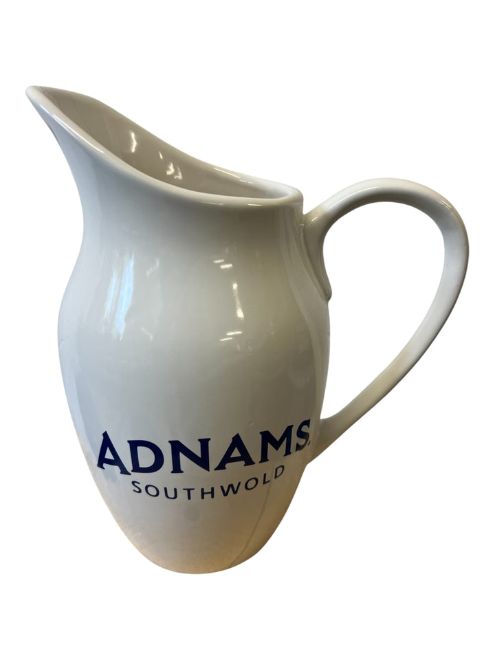 White ceramic pitcher with &