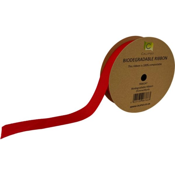Roll of red biodegradable ribbon with a cardboard spool on a white background