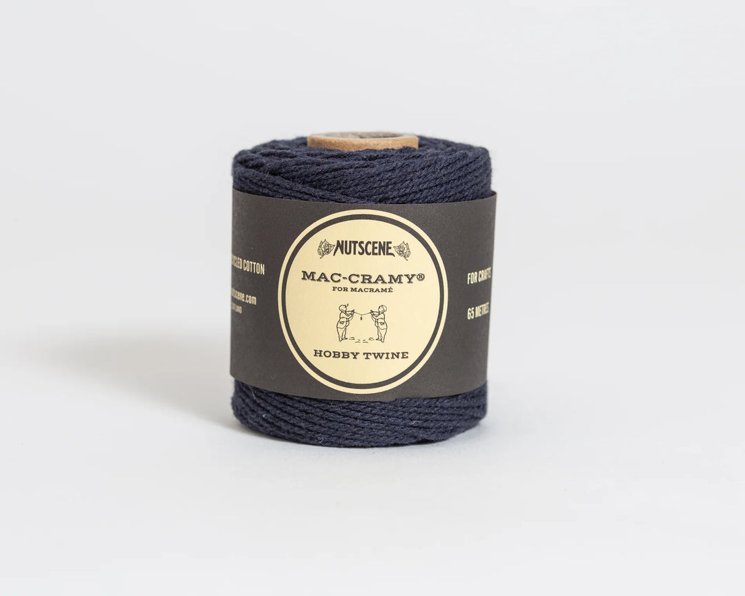 Nautical twine roll with a label on a light gray background