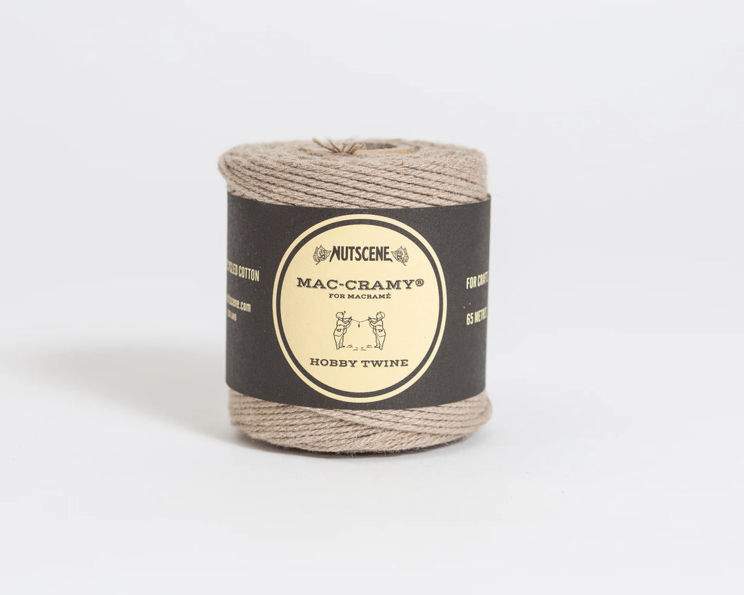 Spool of Macrame twine with a label on a white background