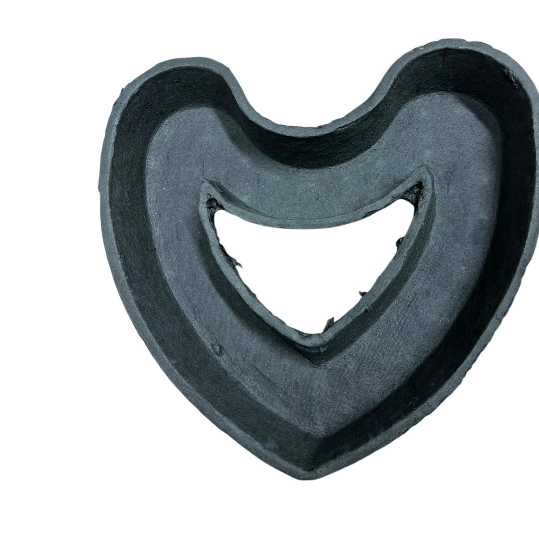 A biodegradable black tray in the shape of a heart designed for funeral tributes and displays.