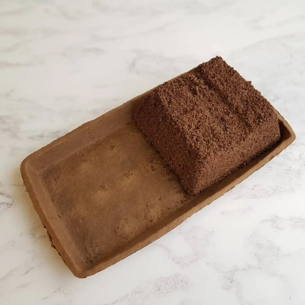 Brown rectangular soap on a white marble surface