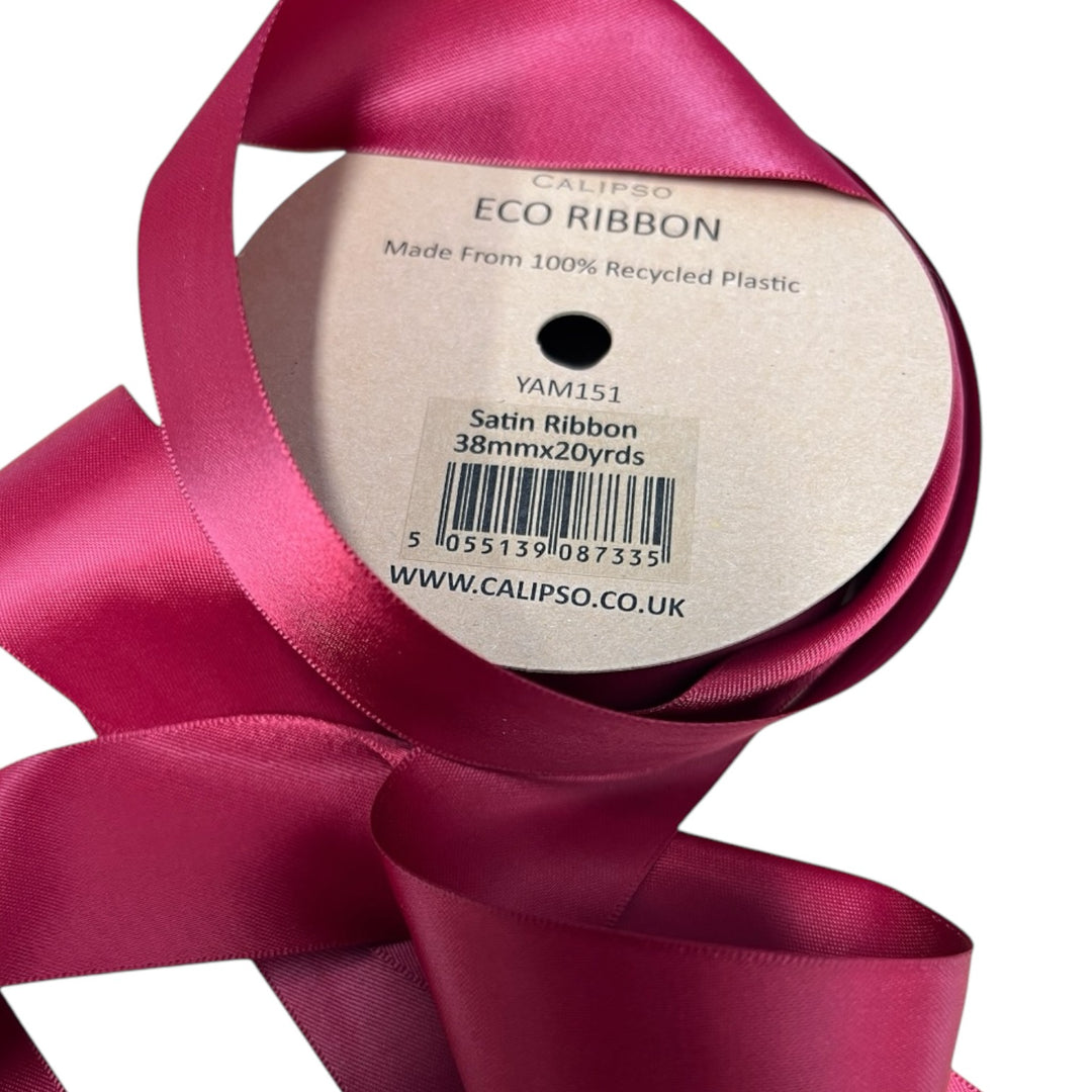 A spool of double faced burgundy satin ribbon with text indicating it is made from recycled plastic bottles.
