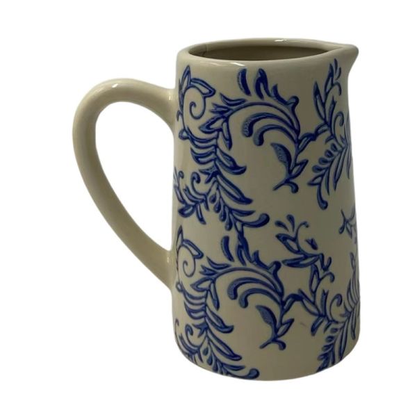 A stoneware jug with blue floral patterns and a natural unglazed section at the base.