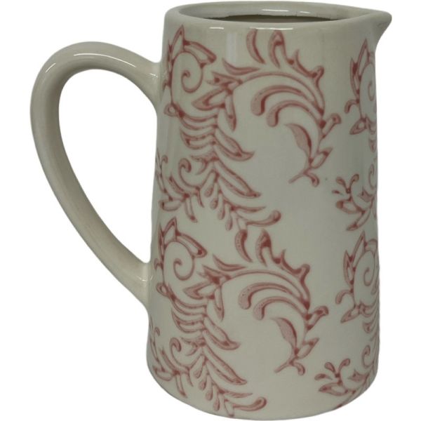 A stoneware jug with a pink floral pattern on a beige background, with a natural unglazed section at the base.