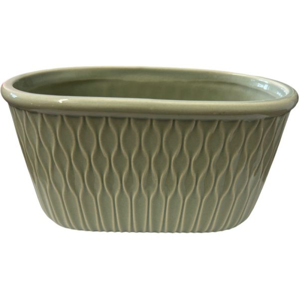 A stoneware oval-shaped container in sage green with a textured pattern and unglazed base.