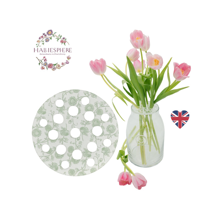 Sage Green Halliesphere 10cm Eco Flower Arranger with botanical pattern graphic shown alongside pink tulip stems in a vase.