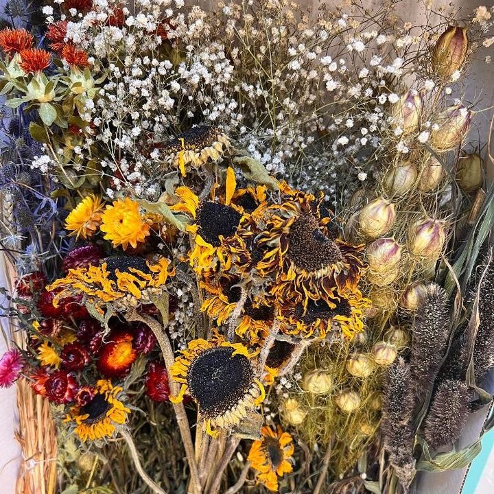 Detailed view of mixed everlasting dried blooms including natural autumn and winter floral tones.