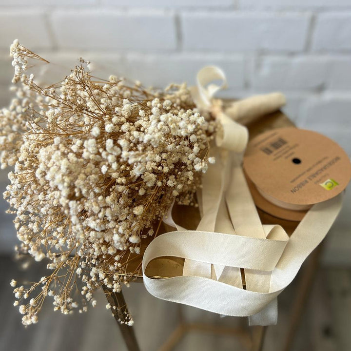 A single bunch of unbleached dried Gypsophila resting on a florist&
