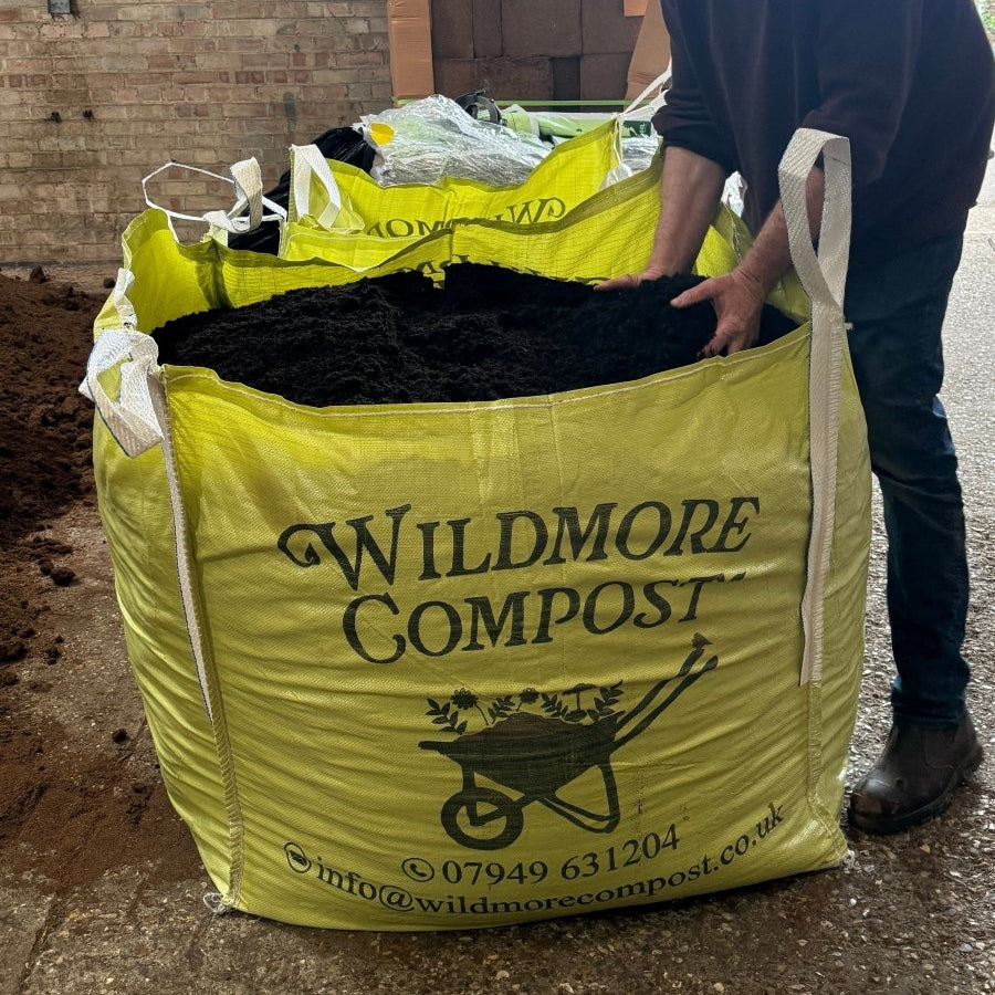 Large yellow bulk bag of Wildmore Compost filled with dark peat-free compost, with contact details printed on the side.